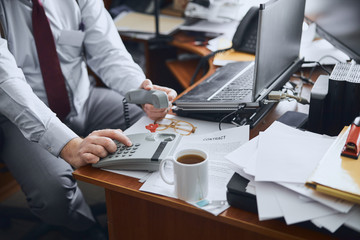 Office worker doing an important call from his cabinet