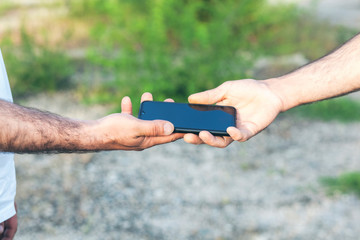person delivering a cell phone to another person