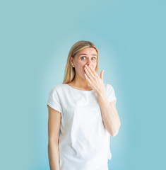 Wow emotion. Portrait young woman looking excited, hand on month, isolated wall. Shocked surprised stunned