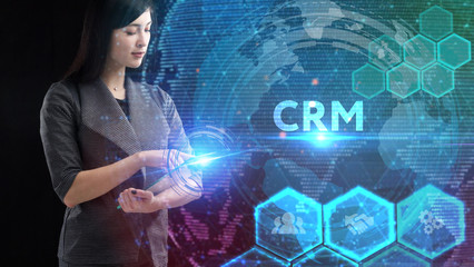 Business, Technology, Internet and network concept. Young businessman working on a virtual screen of the future and sees the inscription: CRM