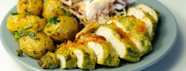 Pesto and mozzarella chicken breast fillet with herby baby potatoes and creamy coleslaw salad