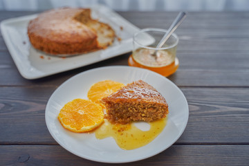 Homemade orange cake on a dark wooden kitchen table. Vegan and Gluten Free.