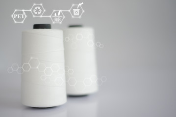Polyester stable fiber & Raw White Polyester FDY Yarn spool with Blurred white background.Chemical...