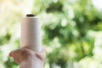 Hand holding Raw White Polyester FDY Yarn spool, Polyester Filament Yarn spool.PET fiber Yarn,spun...
