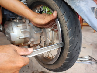 technician fixing wheel the motorcycle