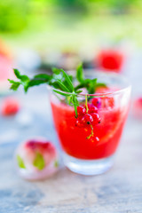 A refreshing drink with red currants and ice.