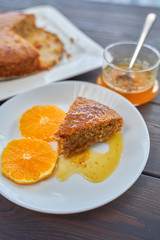 Homemade orange cake on a dark wooden kitchen table. Vegan and Gluten Free.