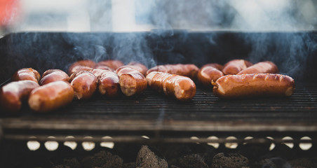 Grilling sausages. Open picnic season
