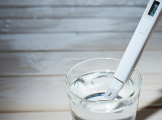 A researcher uses a electric water tester to test the electrical conductivity, TDS, and salt...
