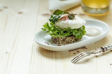 Healthy sandwich for a nutritious snack with poached egg close up