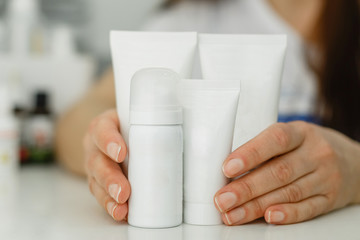Cream tubes for hands and feet on a white background.
