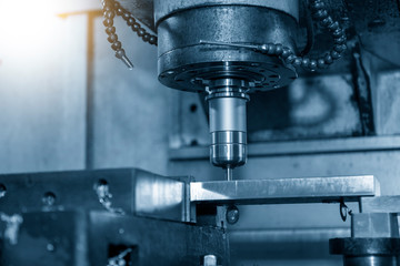 The  CNC  milling machine cutting  the mold parts by solid endmill tool. The hi-technology mold and die manufacturing concept by machining center.