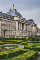 The Royal Palace in Brussels, Belgium from the northeastern corner in spring. National flag of the Kingdom of Belgium waving on top.