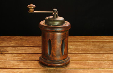 Old coffee grinder on wooden table