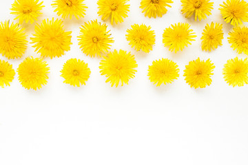 Flowers composition. dandelions on white background. Spring concept. Flat lay, top view copy space. yellow