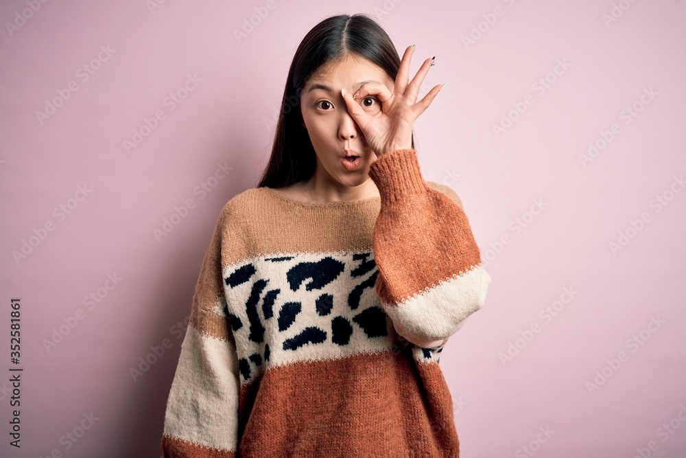 Sticker young beautiful asian woman wearing animal print fashion sweater over pink isolated background doing