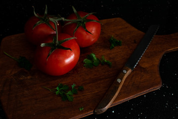 Tomatoes with herbs on a cutting Board