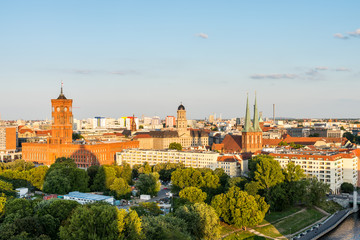 Obraz premium Cityscape of downtown of Berlin with the Red Town Hall and tower of St. Nicholas' Church under sunset. Aerial view from Berlin Cathedral.