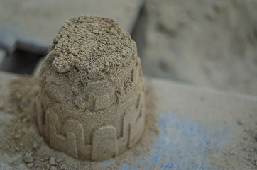 sand castle made by children’s hands on a summer day