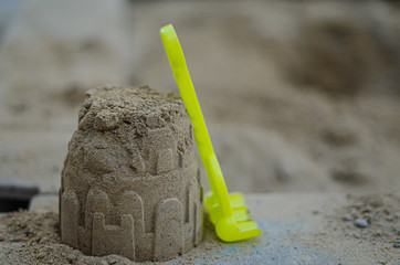 children's rake are in the sandbox at the building of sand