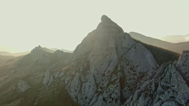 AERIAL flying around the mountain peak because of which the sun's rays peek and in the future you can see the distant mountains