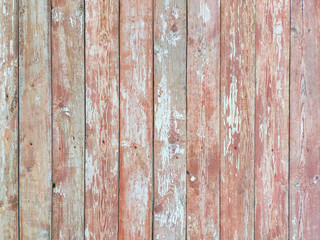 Wooden background - boards with old layered red-white paint. Old painted board with which peeled red paint. The texture of the tree structure.
