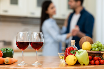 Lovely couple drinking wine in kitchen at home