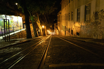 Night view of the Lisbon tram with graffiti.