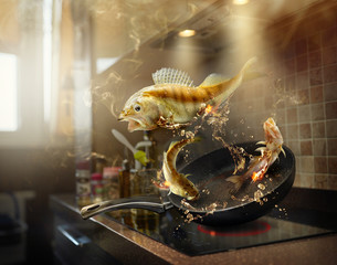 Fishes fly over a pan in fried oil