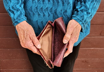Empty wallet in the hands of an elderly woman.Global poverty. A financial crisis .