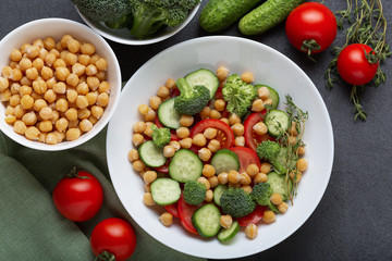 Vegean salad with cheakpea and fresh vegetables, close up. Raw food for cooking fresh salad