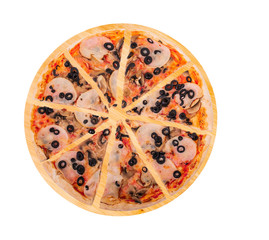Sliced pizza with ham, mozzarella, mushrooms and olives on a round wooden platter, isolated on white background, top view