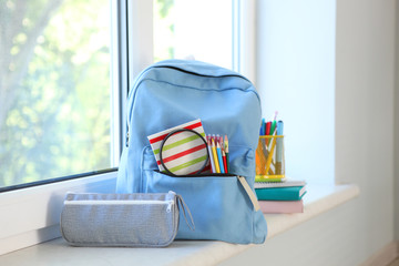 school backpack and stationery in a bright room. Preparing for school. Back to school. Place for...