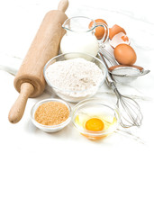 Obraz na płótnie Canvas Kitchen tools food ingredients eggs flour sugar milk