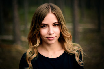 A beautiful young girl in fir tree forest