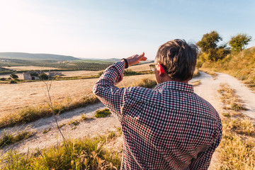 Senior man looking at the horizon in the field. Selective focus.