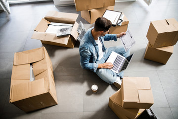 Man with notebook studying layout of new flat