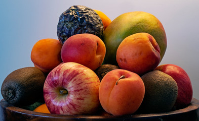 Summer fruit bowl with apricots, apples, mangos, passion fruit and kiwi