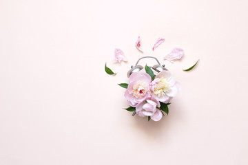 Fototapeta premium Creative minimalistic composition with a Clock. Alarm clock with peony flowers. Spring time. Time to love. Top view.