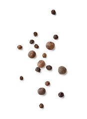 Mix of black pepper and pimento isolated on white background. Top view of allspices and spices.