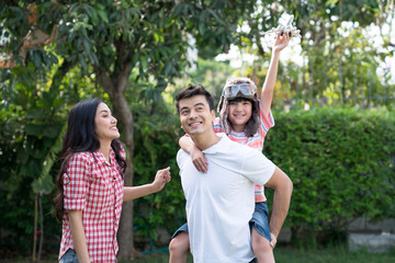 Happy family, Spending time between family members, His parents and son played happily together in front of their home.