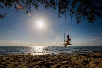 Young woman on swing in tropical Vietnam