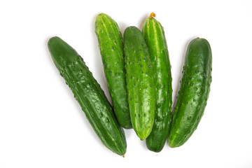 Middle cucumbers on a white isolated background. Flat lay. Fresh vegetables.