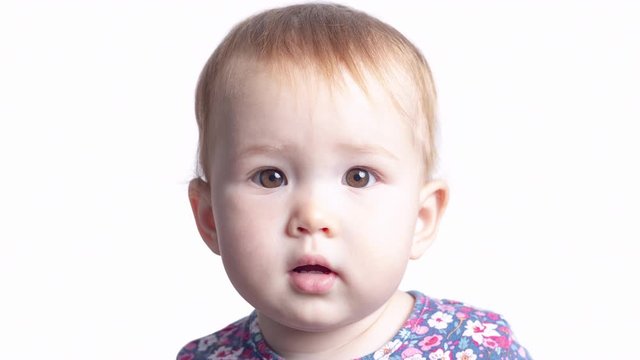 Face transformation of the little girl. Face of the infant baby seven monthes old smoothly transforms into the face of the same baby of one year old. Loopable version