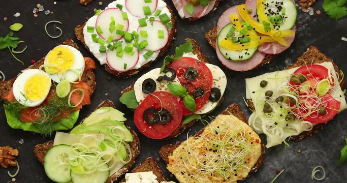 Sandwiches with different kinds of toppings. Placed in rows. Vegetable kitchen concept