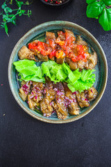 eggplant salad spices and tomatoes, antipasto Menu concept healthy eating. food background top view copy space for text keto or paleo