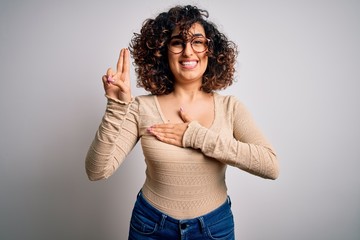 Young beautiful curly arab woman wearing casual t-shirt and glasses over white background smiling...
