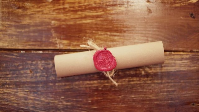 Antique vintage wax seal scroll hanging on a wooden wall