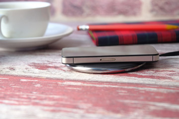 charging Smartphone Using Wireless Charging Pad, top view 