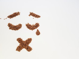 Flax seeds laid out in the form of emotions due to diet.